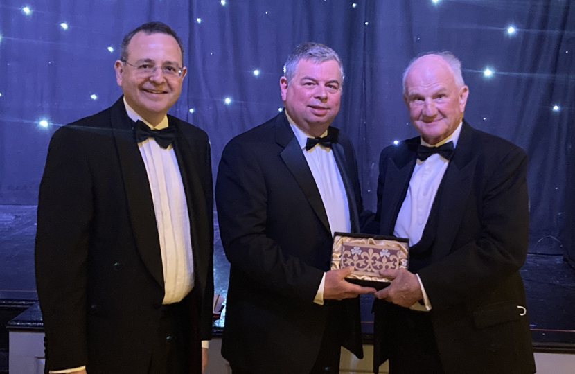 Grahame receiving his gift from Alberto Costa MP and Neil Bannister